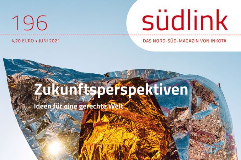 Eine goldglänzende Folie weht umher vor blauem Himmel