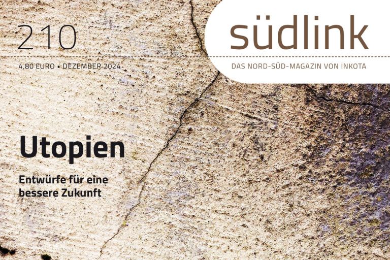 eine graue Steinwand, auf der das Wort "Utopia" in roten Buchstaben gedruckt wurde